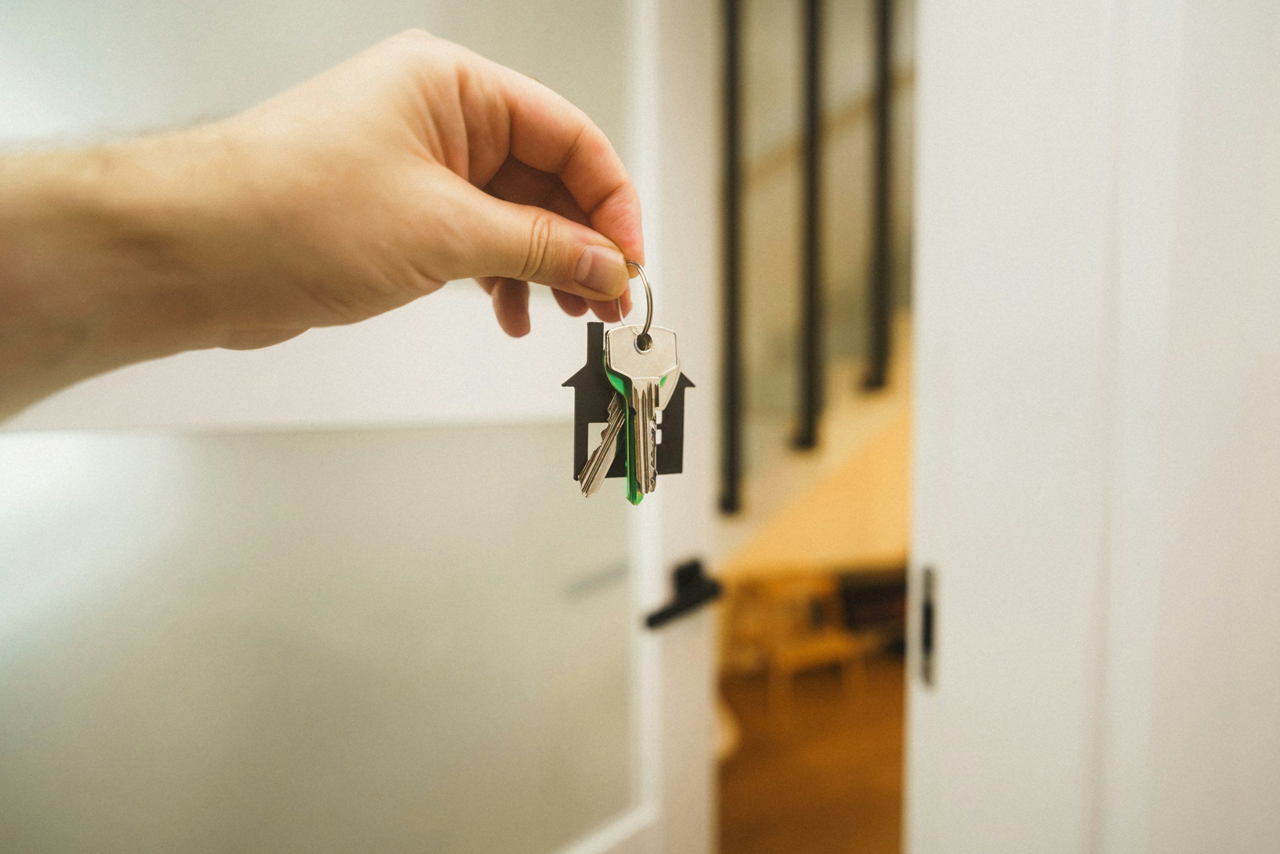 Hand holding house keys